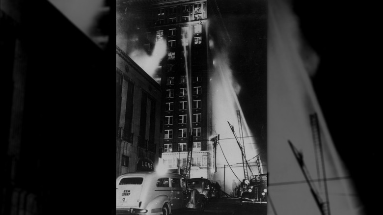 Firehoses blasting water at the top floors of the Winecoff Hotel during the fire in 1946