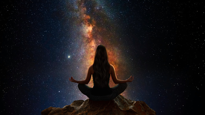 Woman mediating towards cosmos