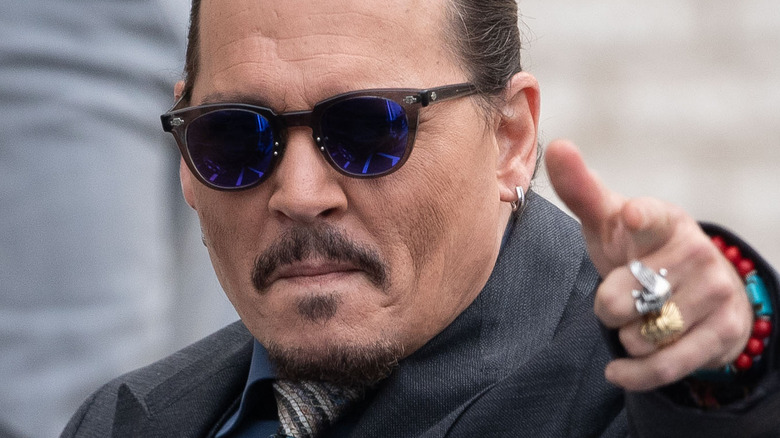 Johnny Depp pointing outside his defamation trial