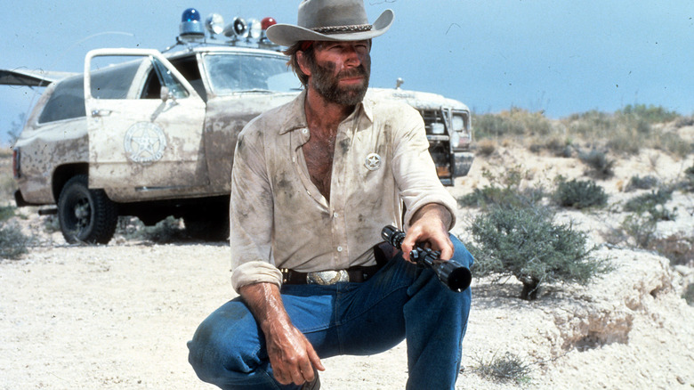 Chuck Norris kneeling in desert