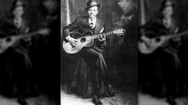 Robert Johnson posing with guitar