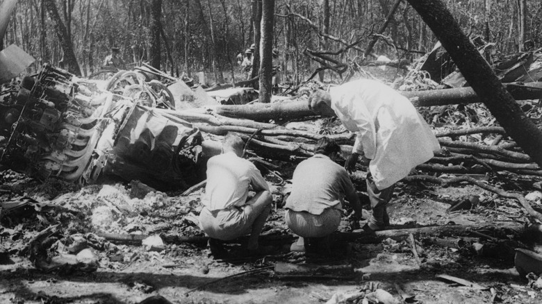 Dag Hammarskjöld crash two men crouching one bent over