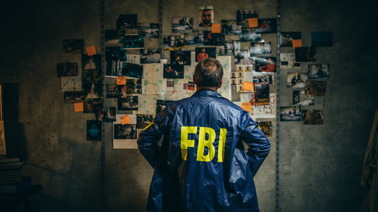 FBI agent looking at evidence board
