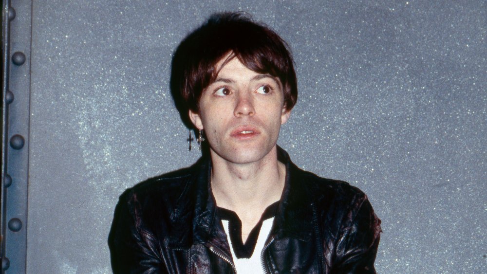A profile shot of Richey Edwards in a black leather jacket