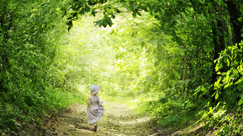 girl walking through a forest