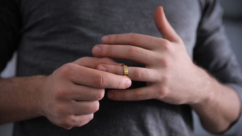 Man taking wedding ring off
