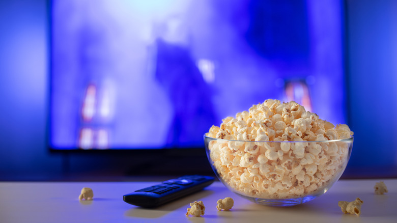 uneaten bowl of popcorn in front of TV
