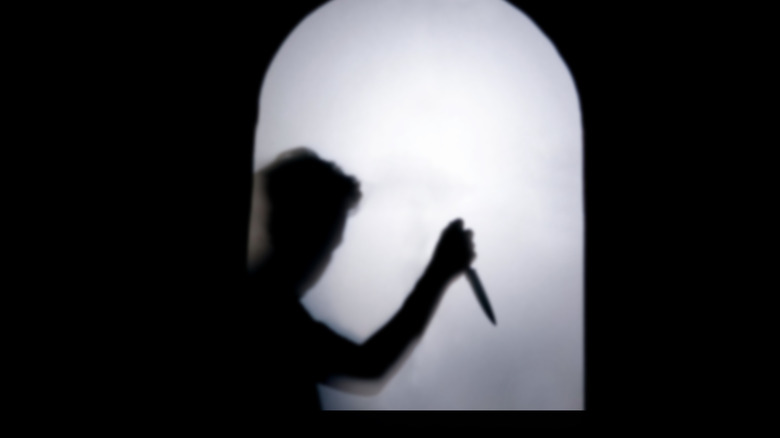 Someone's shadow holding knife