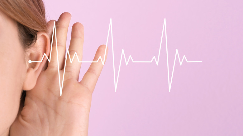 Hand to ear, with audio waves 