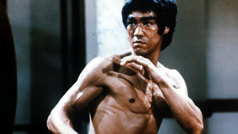 Bruce Lee holding up hands