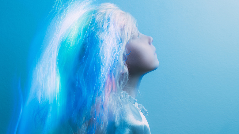 White-haired mystical child staring up