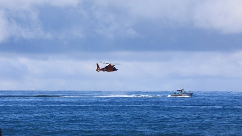 Helicopter and boat at sea