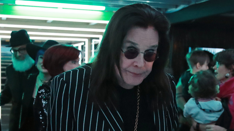 Ozzy Osbourne walking with cane