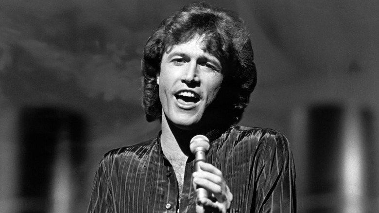Andy Gibb singing on stage