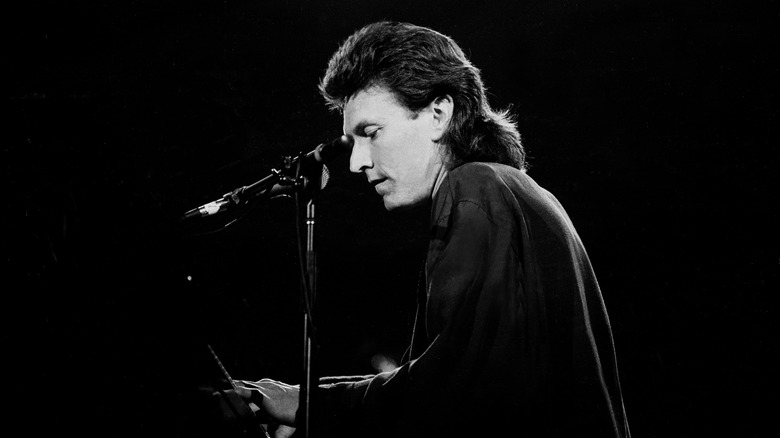 Steve Winwood playing piano near microphone