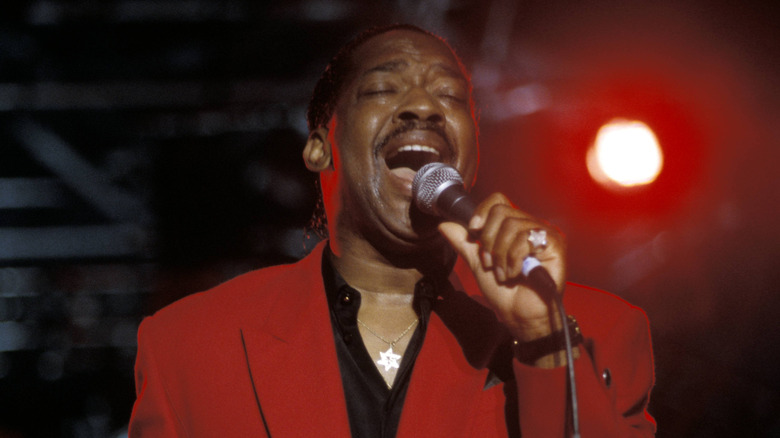 Edwin Starr singing in red jacket on stage