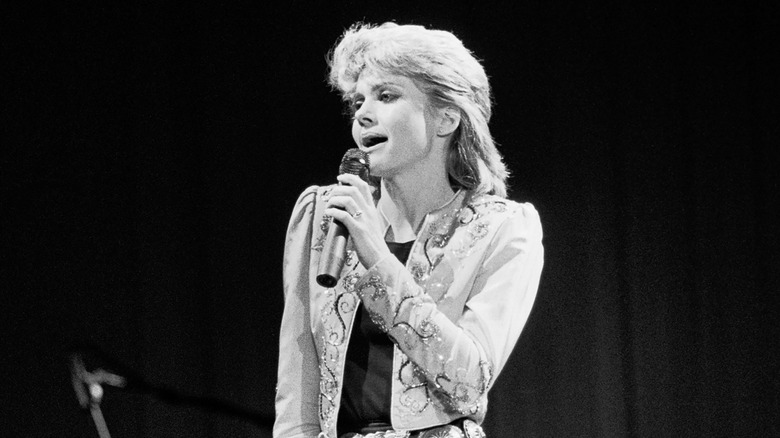 Olivia Newton-John singing onstage in the '80s