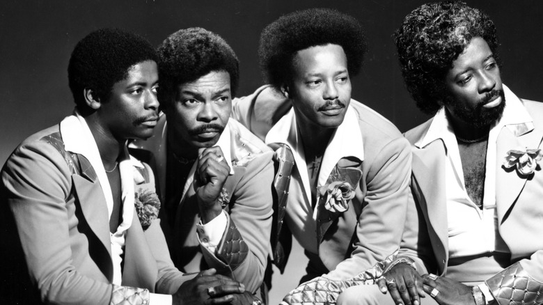 The Manhattans posing and looking away