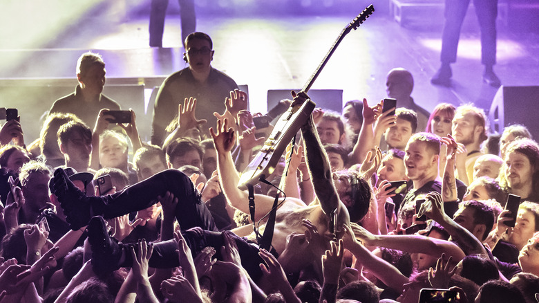 Guitarist crowd-surfing at concert