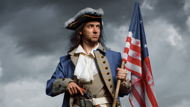 revolutionary war era guy holding a flag