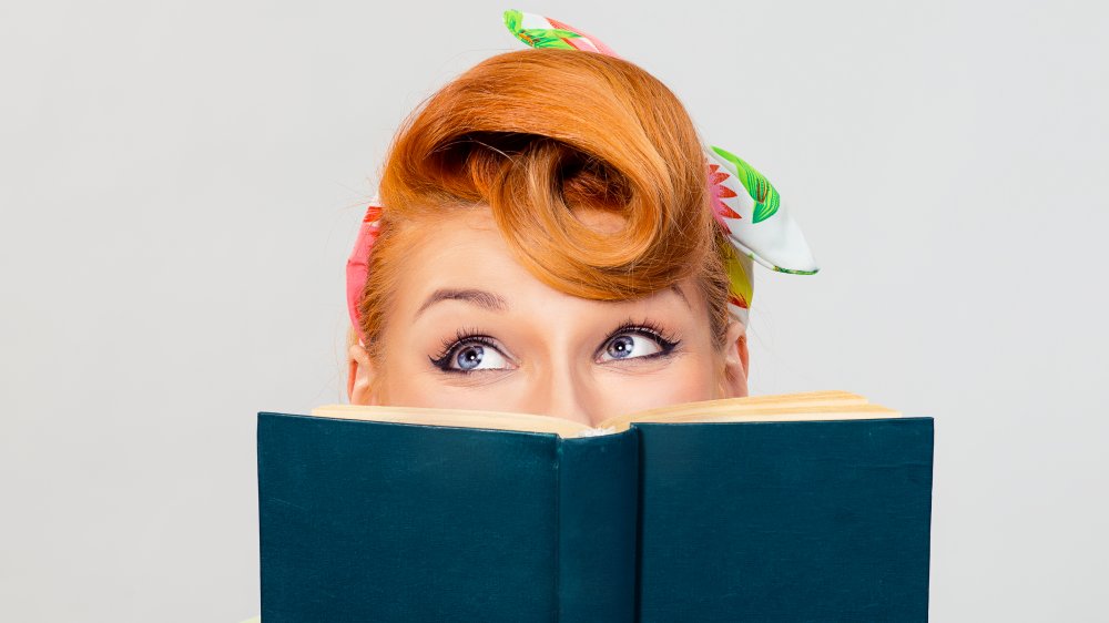 retro-looking woman reading book