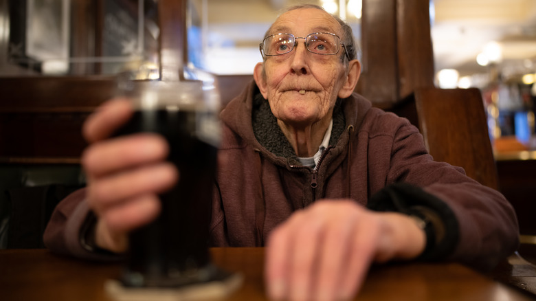 old man drinking pint