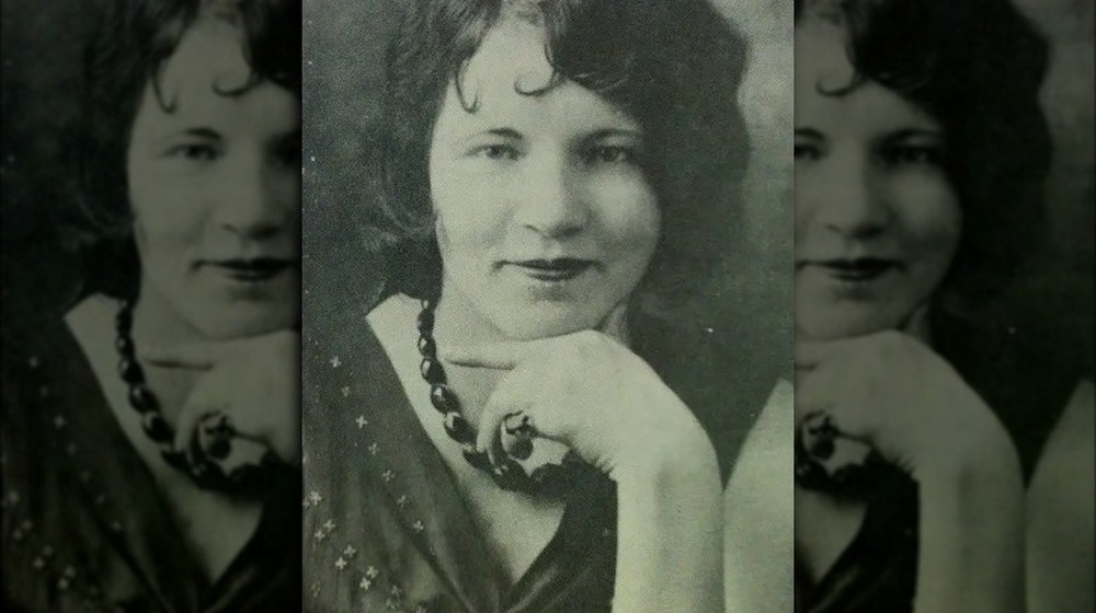 Olga Mauger smiling  with hand on chin