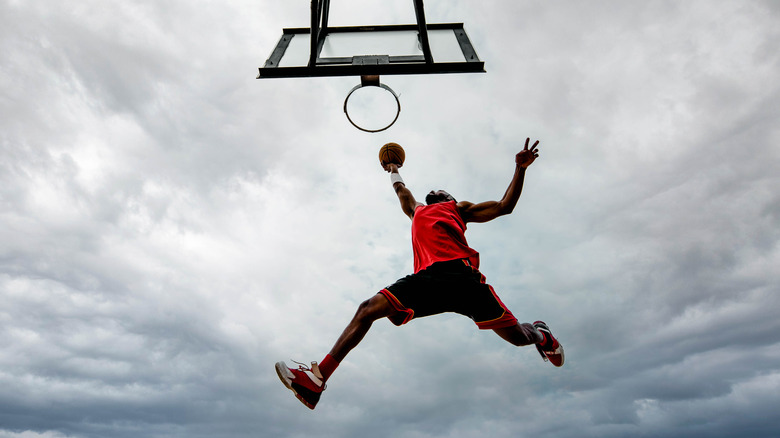 Guy making slam dunk