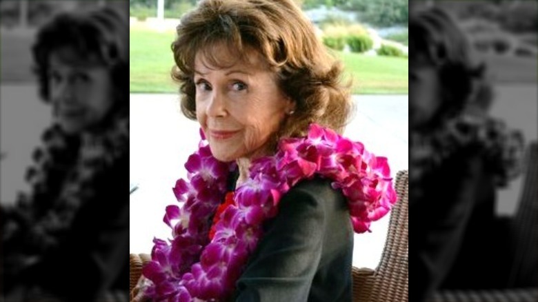 caren marsh-doll sat wearing lei