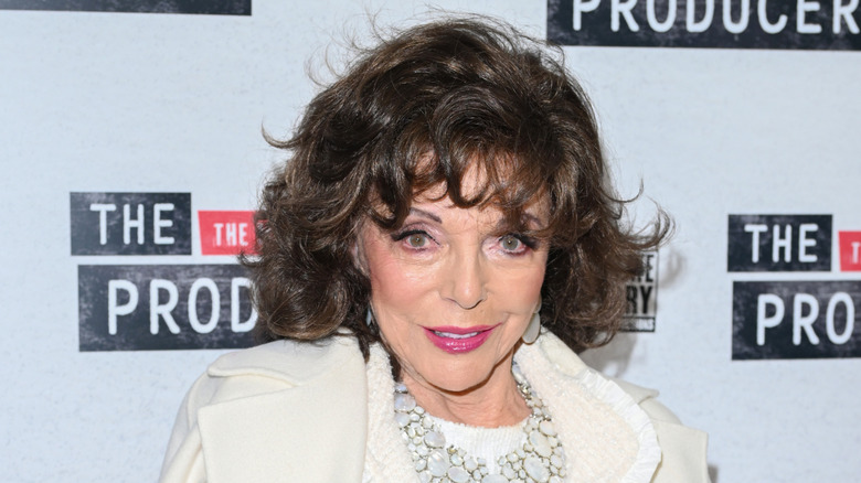 joan collins attends a 2025 event in white outfit