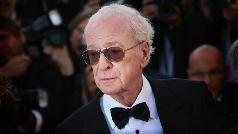 Michael Caine black suit bowtie sunglasses