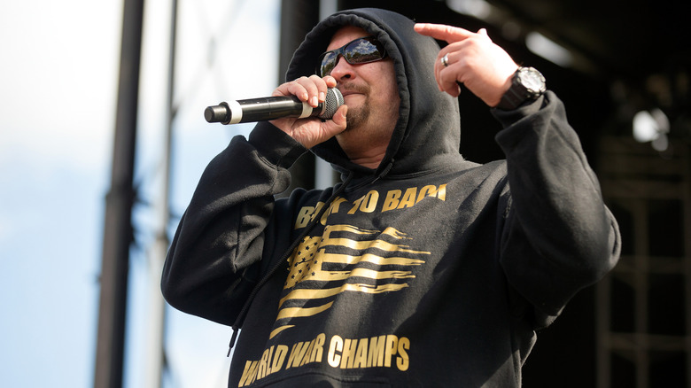 Chris Volz in hoody and sunglasses singing on stage