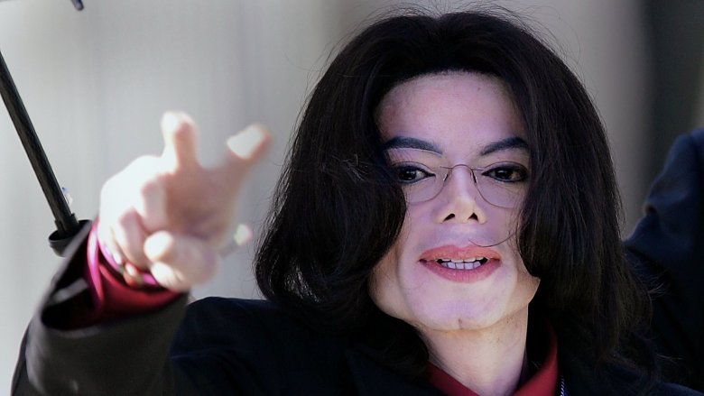 Michael Jackson with glasses hand raised pointing to camera
