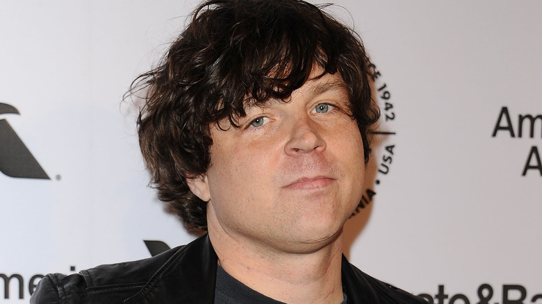 Ryan Adams dark hair in leather jacket at event