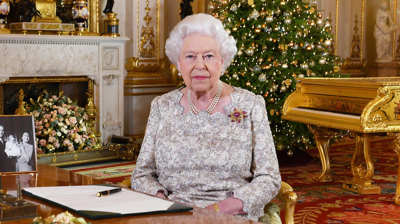 Queen Elizabeth II sitting at desk