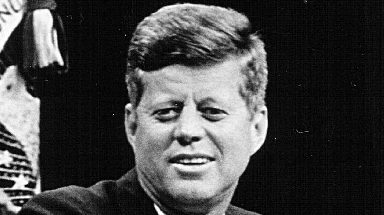 JFK smiling hand podium