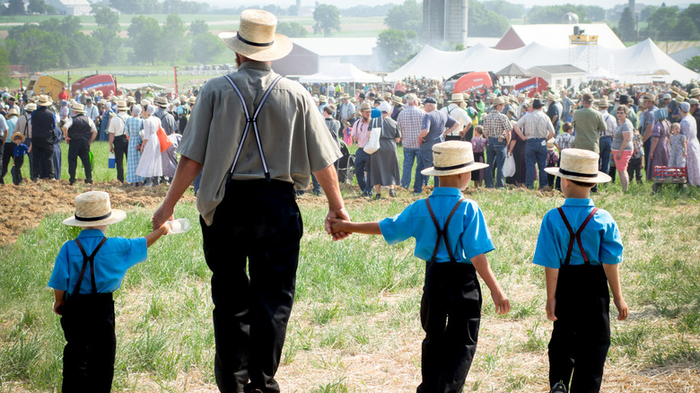 Amish family holding hands