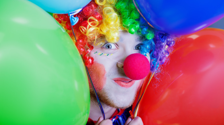 Clown hiding within balloons