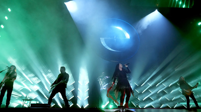 Evanescence performing in February 2023 against a backdrop of their logo