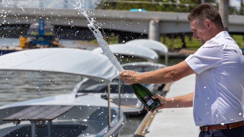 popping champagne over a ship