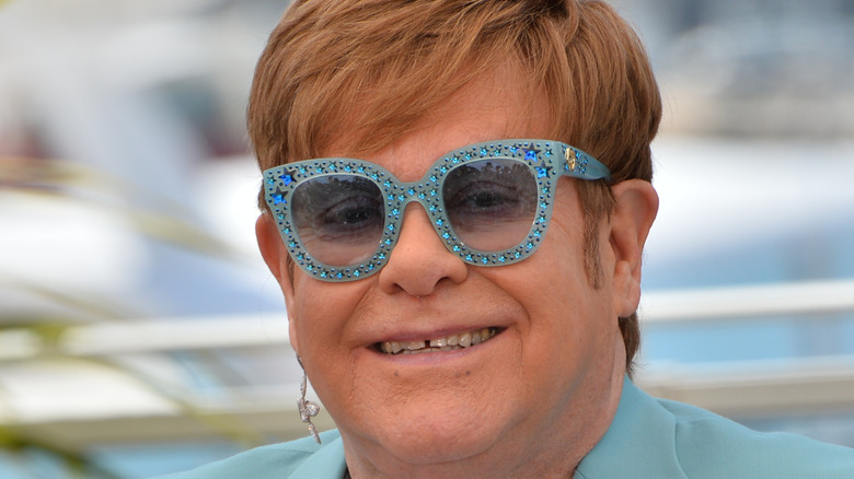 Elton John in blue sunglasses