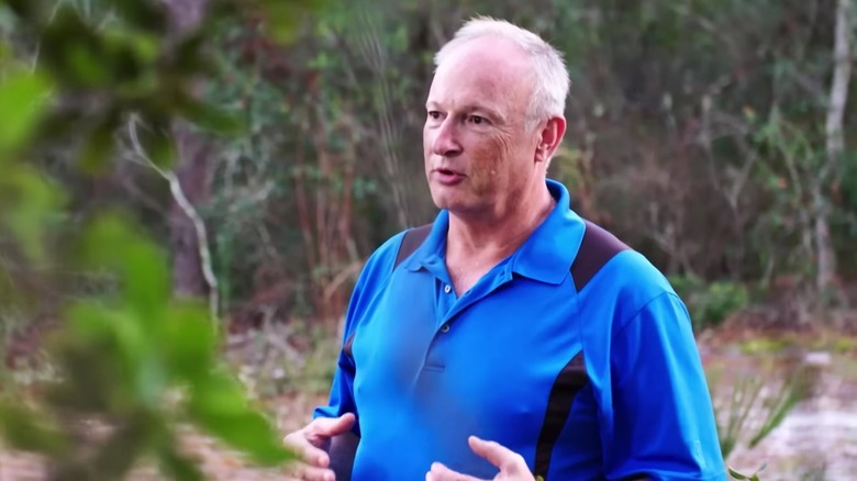 Brian Jarvis speaking in a wooded area