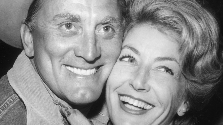 Kirk Douglas gives wife a hug