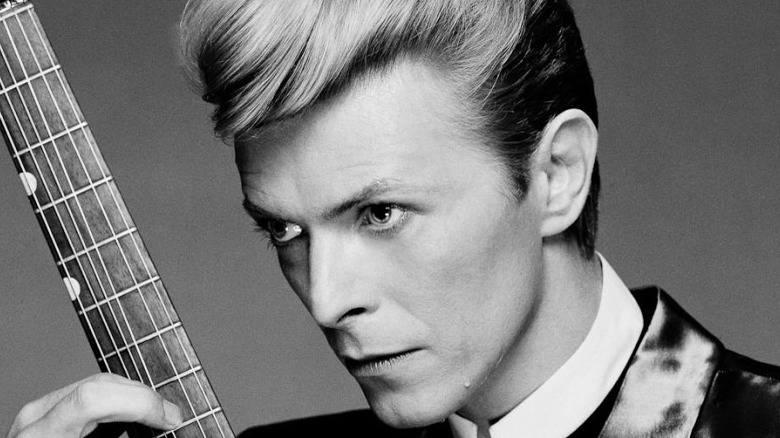 David Bowie holding a guitar