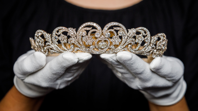 white gloved hands holding Spencer Tiara