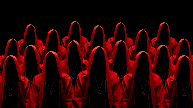 faceless figures wearing red robes