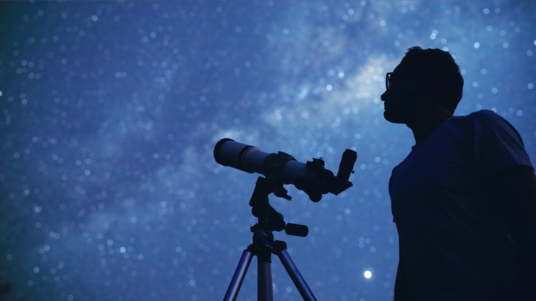 Person looking through telescope