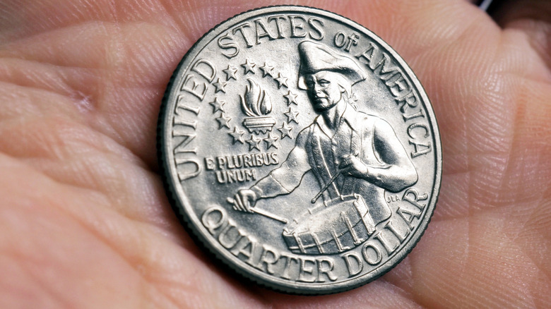Reverse side of a Bicentennial Quarter in the palm of a hand