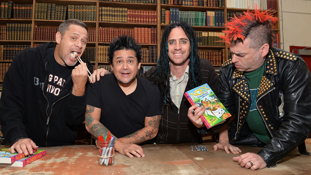 NOFX members Erik Sandin, El Hefe, Eric Melvin, and Fat Mike (L-R) pose at a 2016 book signing.
