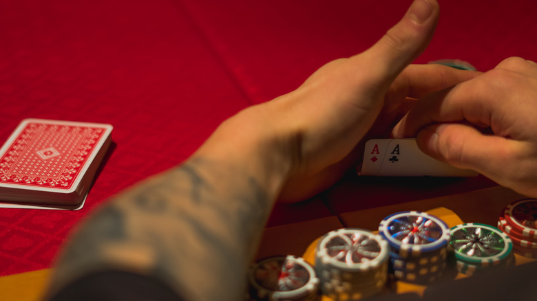 Guy checking poker hand
